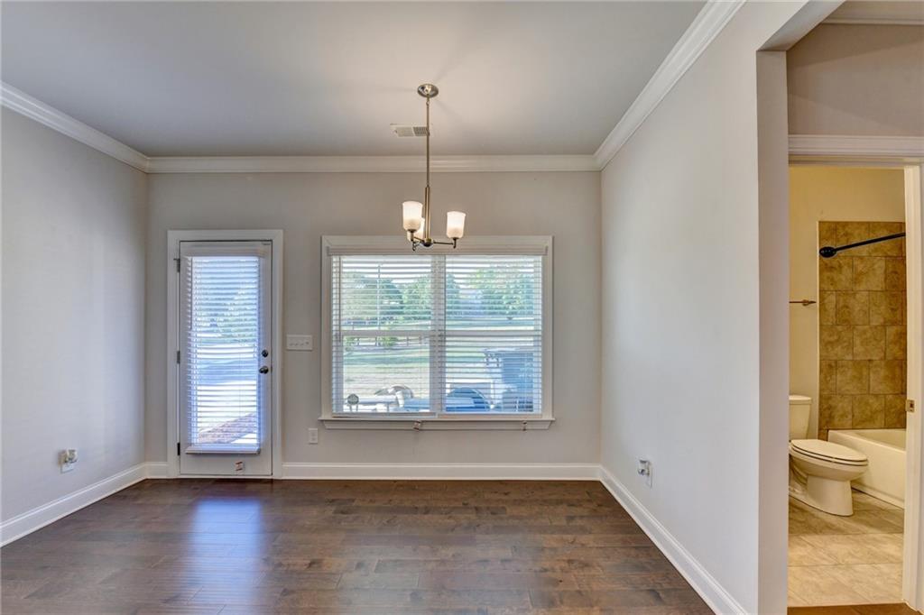 4548 Red Blossom Trail Southwest Powder Springs, GA 30127 - Photo 27 of 72 a view of an empty room with wooden floor and a window