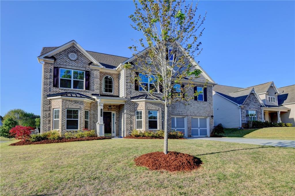 4548 Red Blossom Trail Southwest Powder Springs, GA 30127 - Photo 3 of 72 a front view of a house with a yard