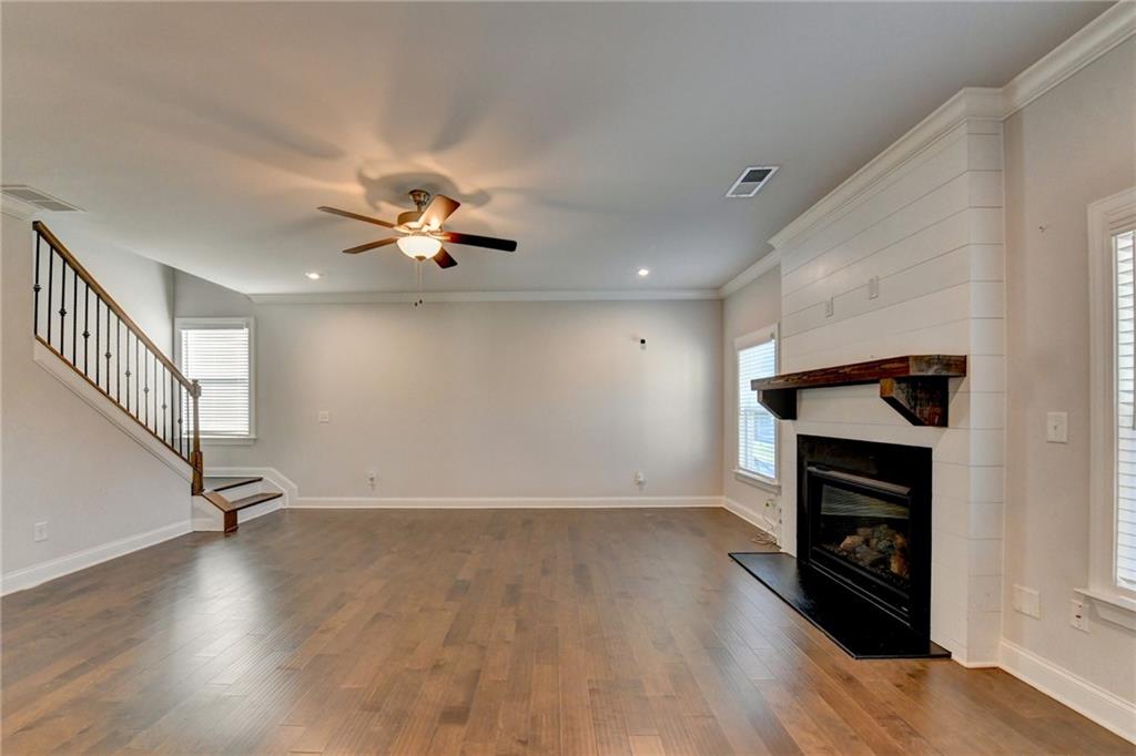 4548 Red Blossom Trail Southwest Powder Springs, GA 30127 - Photo 37 of 72 wooden floor in an empty room with a fireplace
