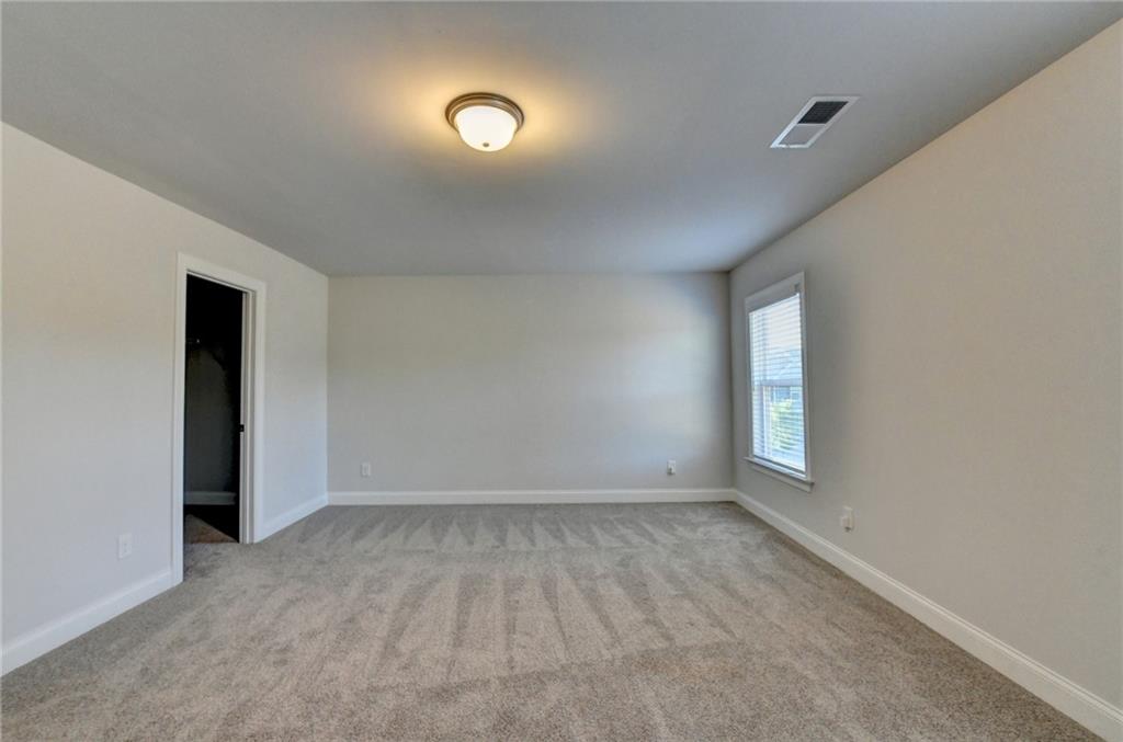4548 Red Blossom Trail Southwest Powder Springs, GA 30127 - Photo 42 of 72 an empty room with windows and closet