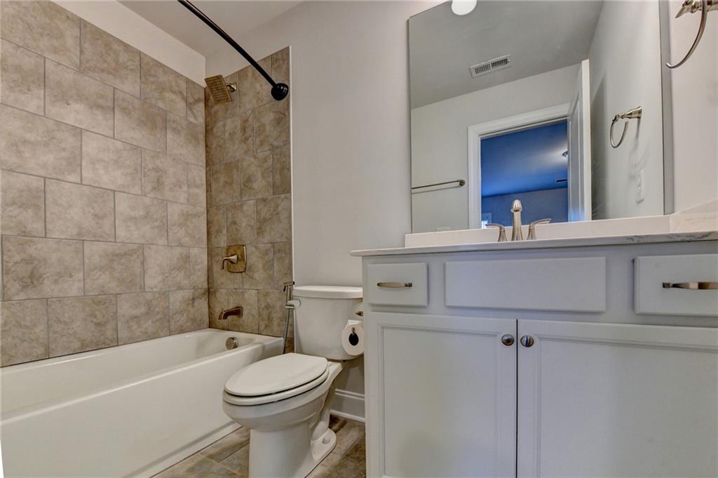 4548 Red Blossom Trail Southwest Powder Springs, GA 30127 - Photo 44 of 72 a bathroom with a sink a toilet and a mirror