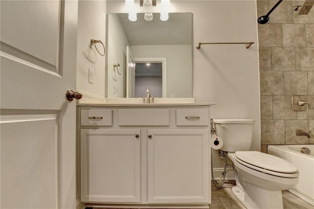 4548 Red Blossom Trail Southwest Powder Springs, GA 30127 - Photo 52 of 72 a bathroom with a sink a toilet and shower