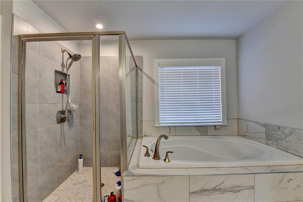 4548 Red Blossom Trail Southwest Powder Springs, GA 30127 - Photo 61 of 72 a bathroom with a tub and a shower