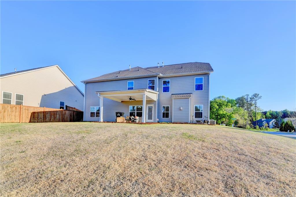 4548 Red Blossom Trail Southwest Powder Springs, GA 30127 - Photo 69 of 72 a view of a house with a yard and garage