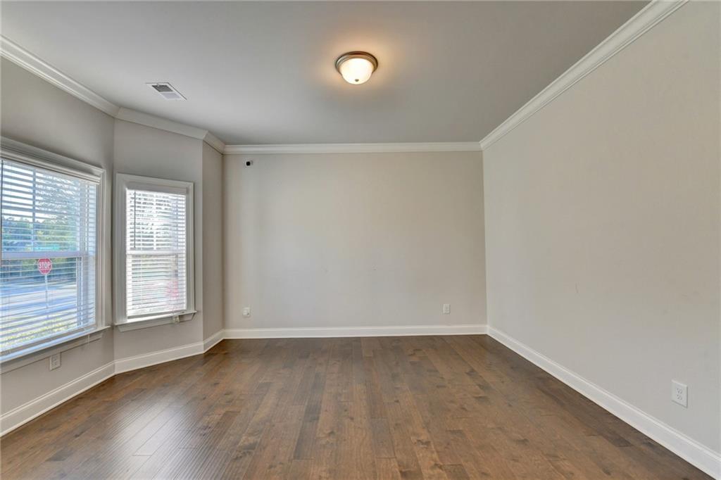 4548 Red Blossom Trail Southwest Powder Springs, GA 30127 - Photo 7 of 72 an empty room with wooden floor and windows