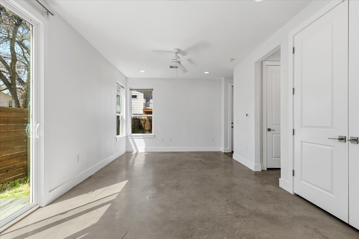 1114 Walton Lane, Unit A Austin, TX 78721 - Photo 11 of 36 Livingroom with concrete floors, a ceiling fan, and recessed lighting.