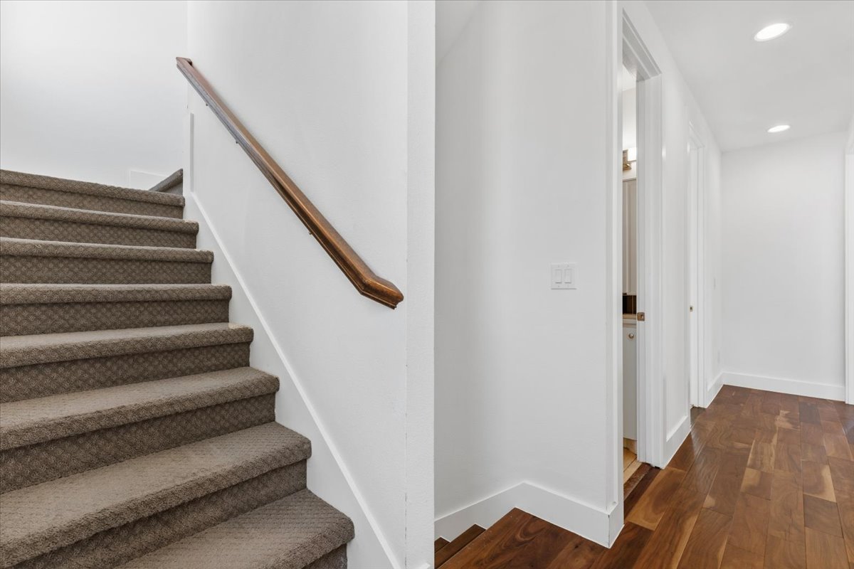 1114 Walton Lane, Unit A Austin, TX 78721 - Photo 12 of 36 Stairway with recessed lighting and wood finished floors