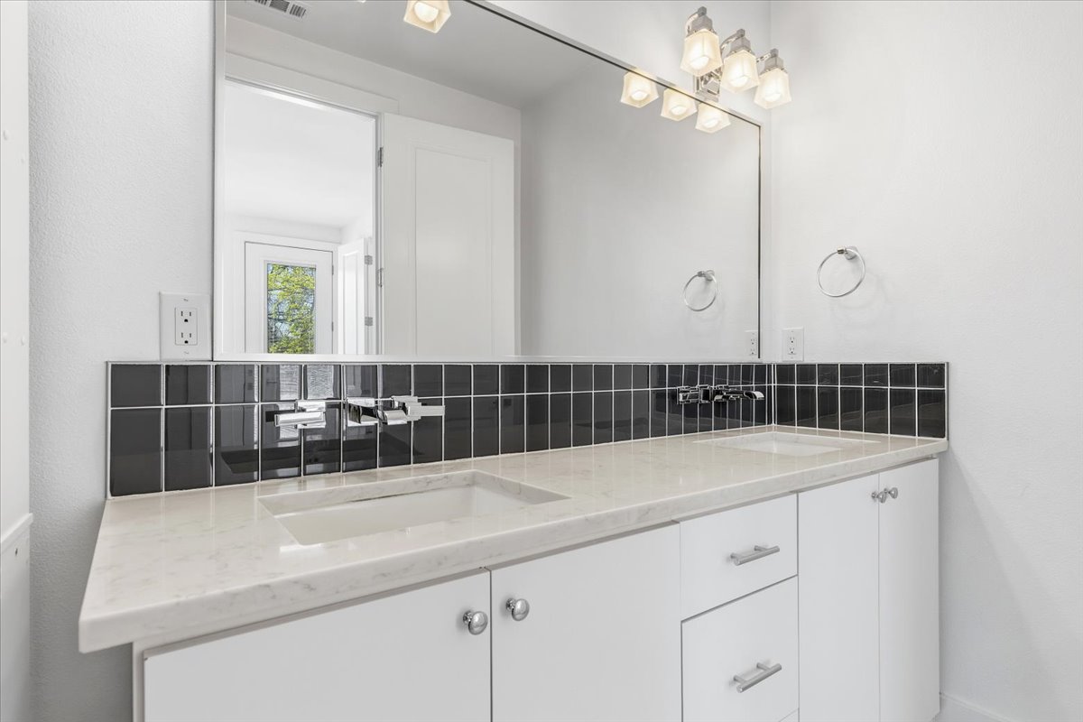 1114 Walton Lane, Unit A Austin, TX 78721 - Photo 13 of 36 Full bath with double vanity and backsplash