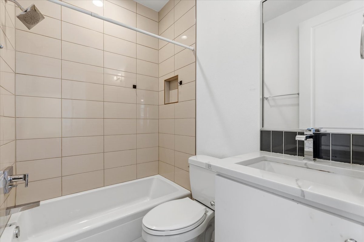1114 Walton Lane, Unit A Austin, TX 78721 - Photo 14 of 36 Bathroom with vanity and shower / washtub combination