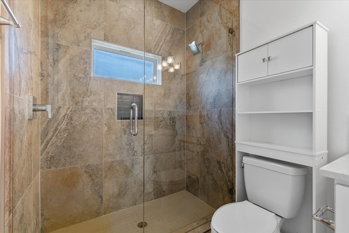 1114 Walton Lane, Unit A Austin, TX 78721 - Photo 19 of 36 Bathroom with toilet and a shower stall