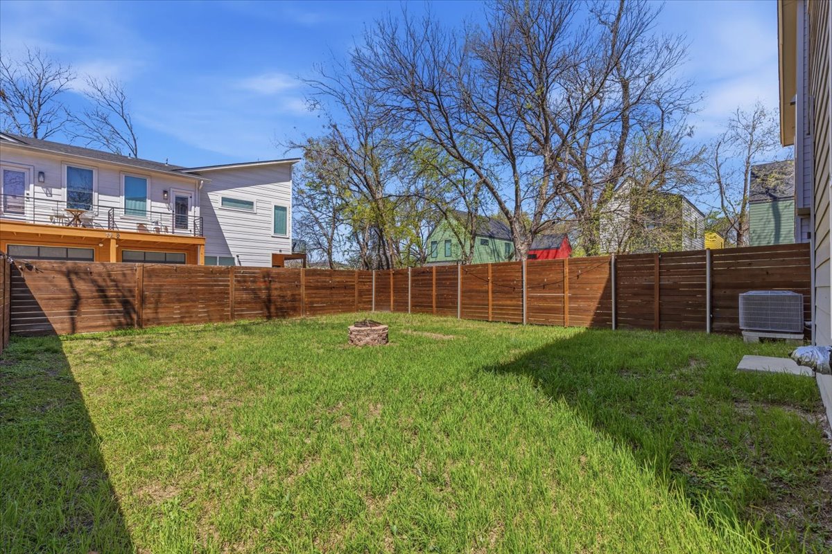 1114 Walton Lane, Unit A Austin, TX 78721 - Photo 29 of 36 Fenced backyard featuring an outdoor fire pit.