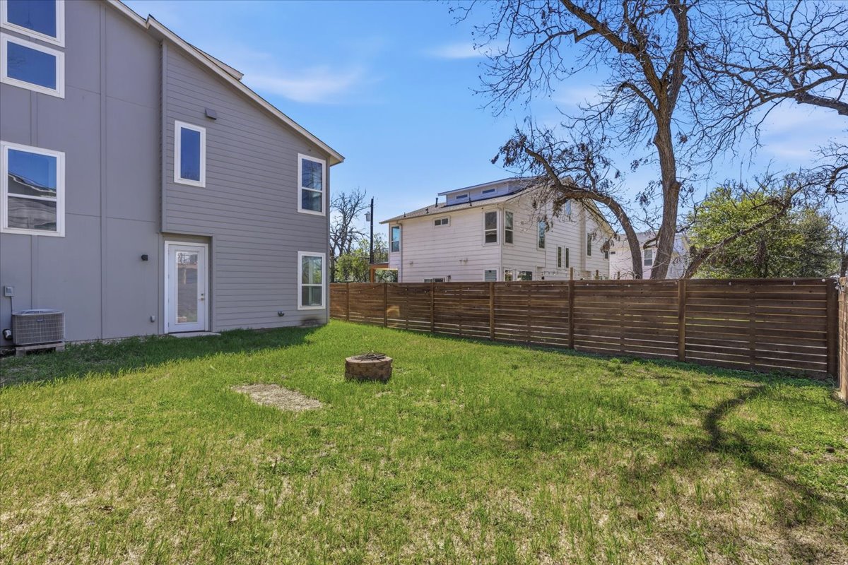 1114 Walton Lane, Unit A Austin, TX 78721 - Photo 31 of 36 Fenced backyard featuring a fire pit