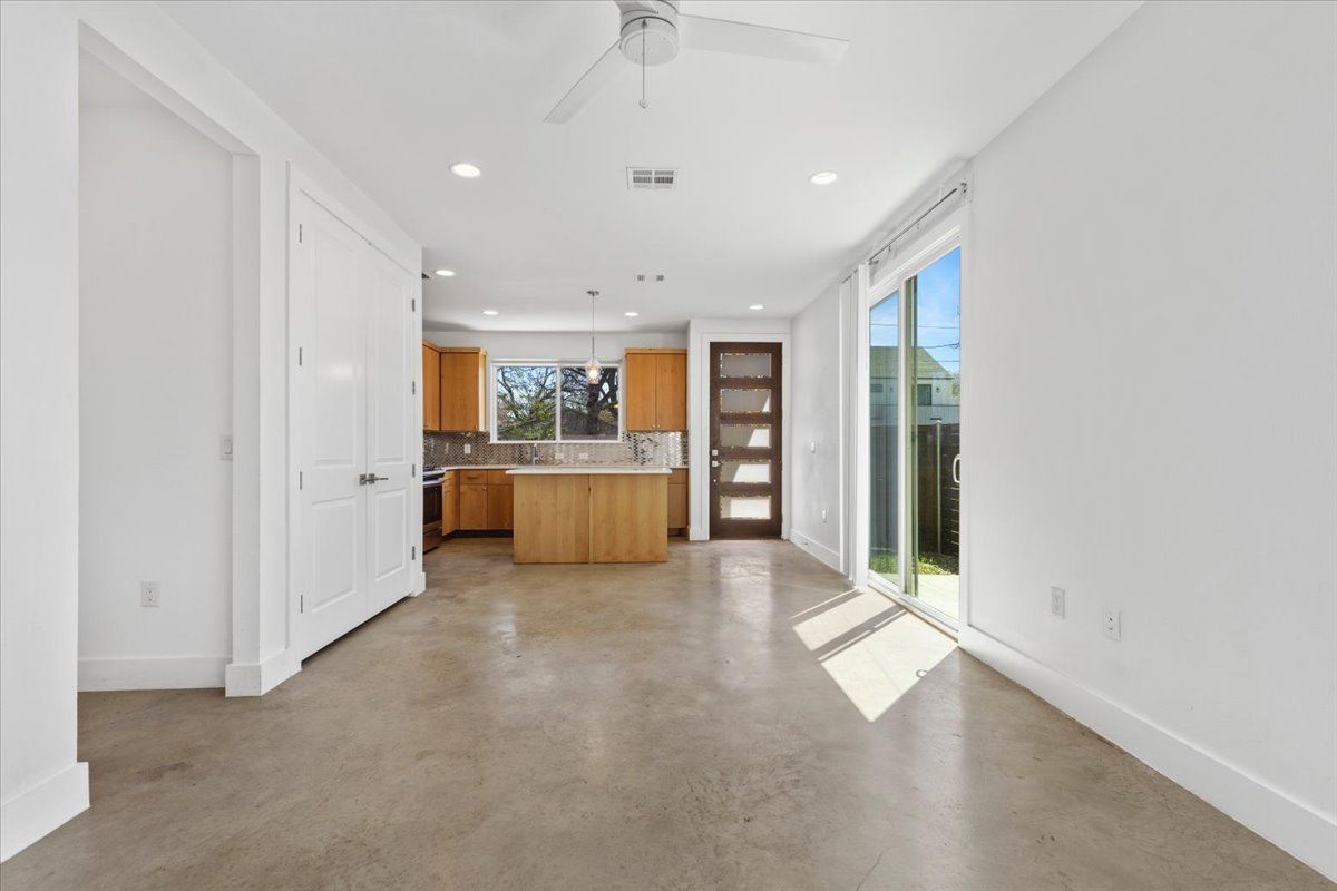 1114 Walton Lane, Unit A Austin, TX 78721 - Photo 36 of 36 Kitchen with a kitchen island, light countertops, tasteful backsplash, finished concrete floors, and open floor plan