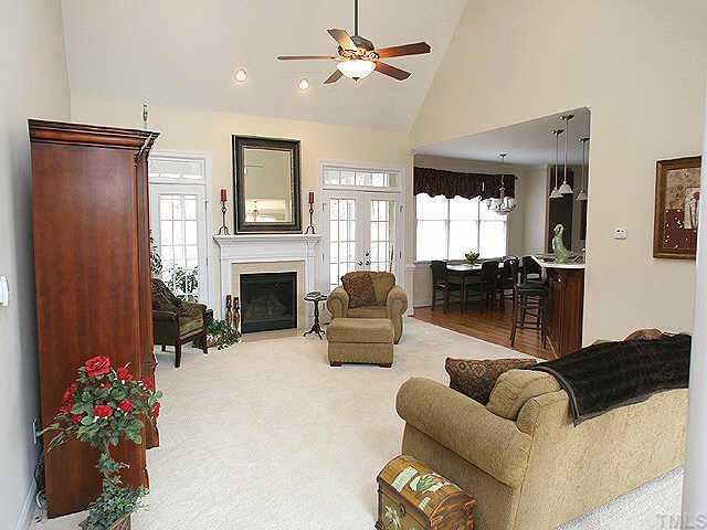 Living room with fireplace and soaring vaulted ceiling