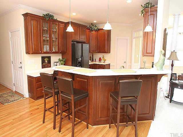 Spacious kitchen, Corian counters, cherry wood cabinets, hardwood floors