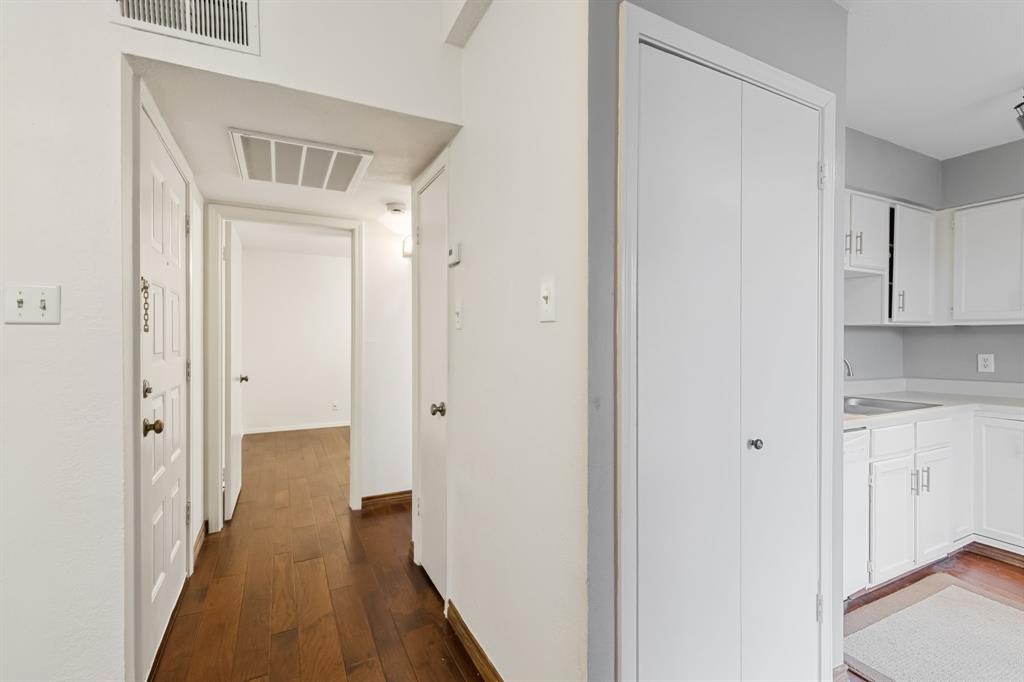 4748 Old Bent Tree Lane, Unit 1808 Dallas, TX 75287 - Photo 8 of 28 a view of a hallway with wooden floor