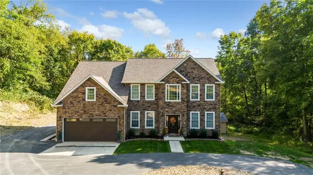 a front view of a house with a yard and garage
