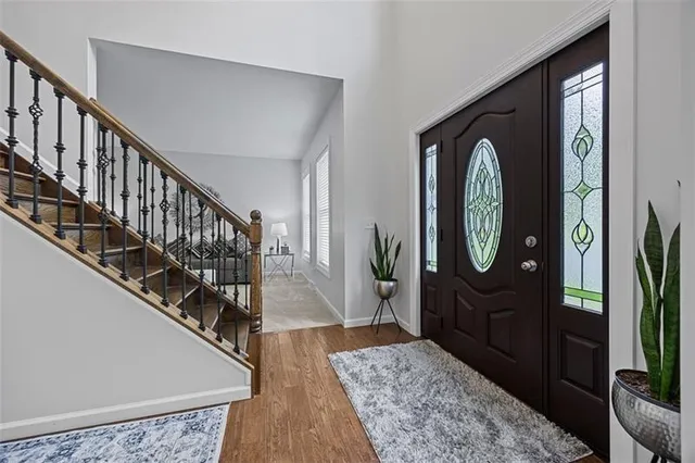a view of a hallway with wooden floor entryway and a living room