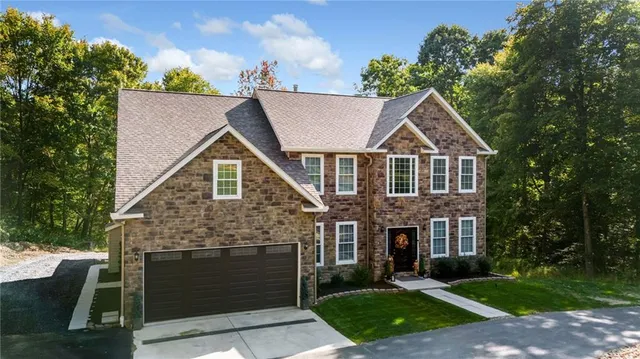 a front view of a house with yard