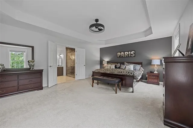 a spacious bedroom with a bed and a table