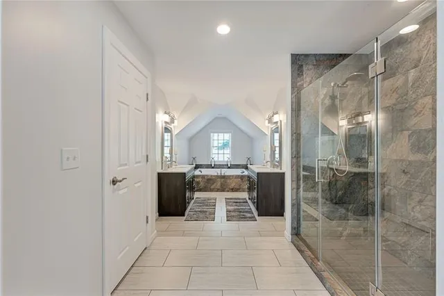 a bathroom with a glass shower door and a sink