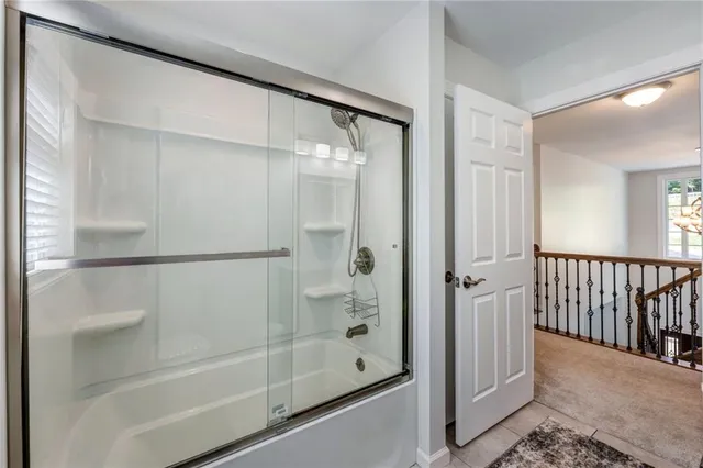 a bathroom with a glass shower door