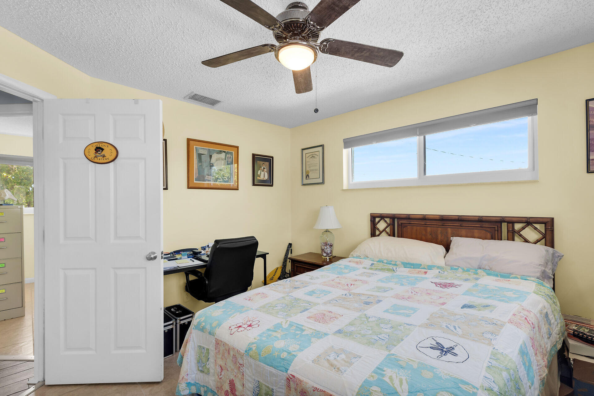 119 Primrose Lane Long Key, FL 33001 - Photo 18 of 43 a bedroom with a bed and a chandelier