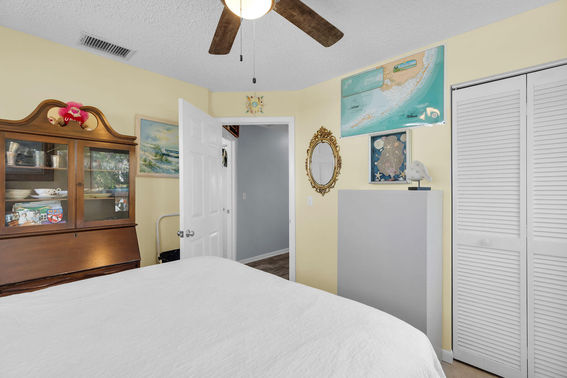 119 Primrose Lane Long Key, FL 33001 - Photo 19 of 43 a bedroom with a bed and a chandelier