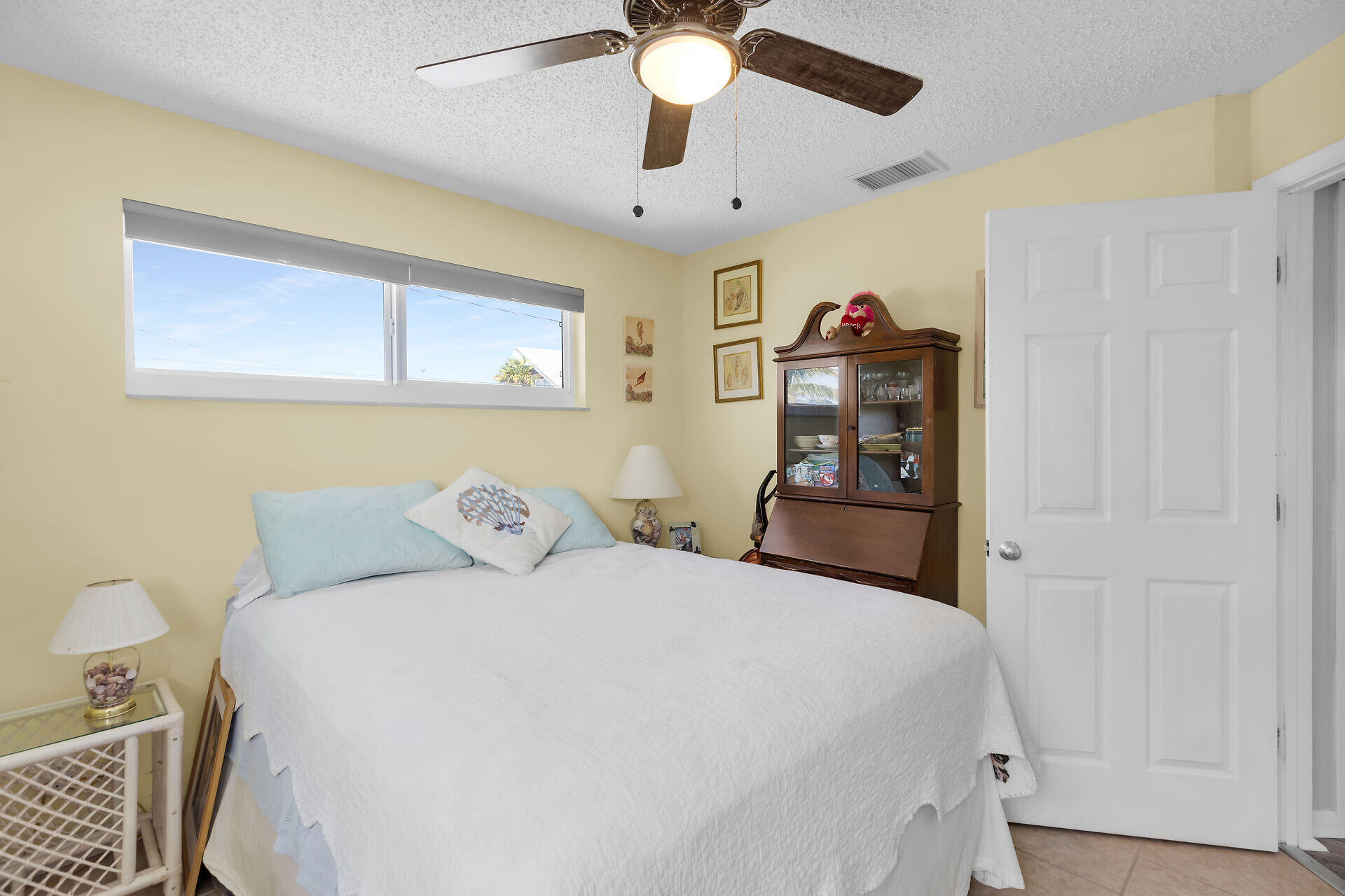 119 Primrose Lane Long Key, FL 33001 - Photo 21 of 43 a bedroom with a bed and a chandelier