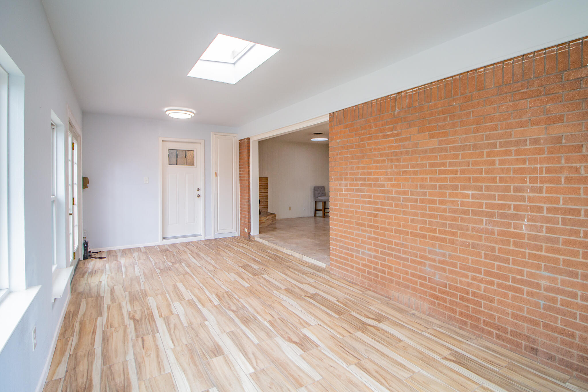 2806 58th Street Lubbock, TX 79413 - Photo 18 of 35 a view of an empty room and a bathroom with wooden floor