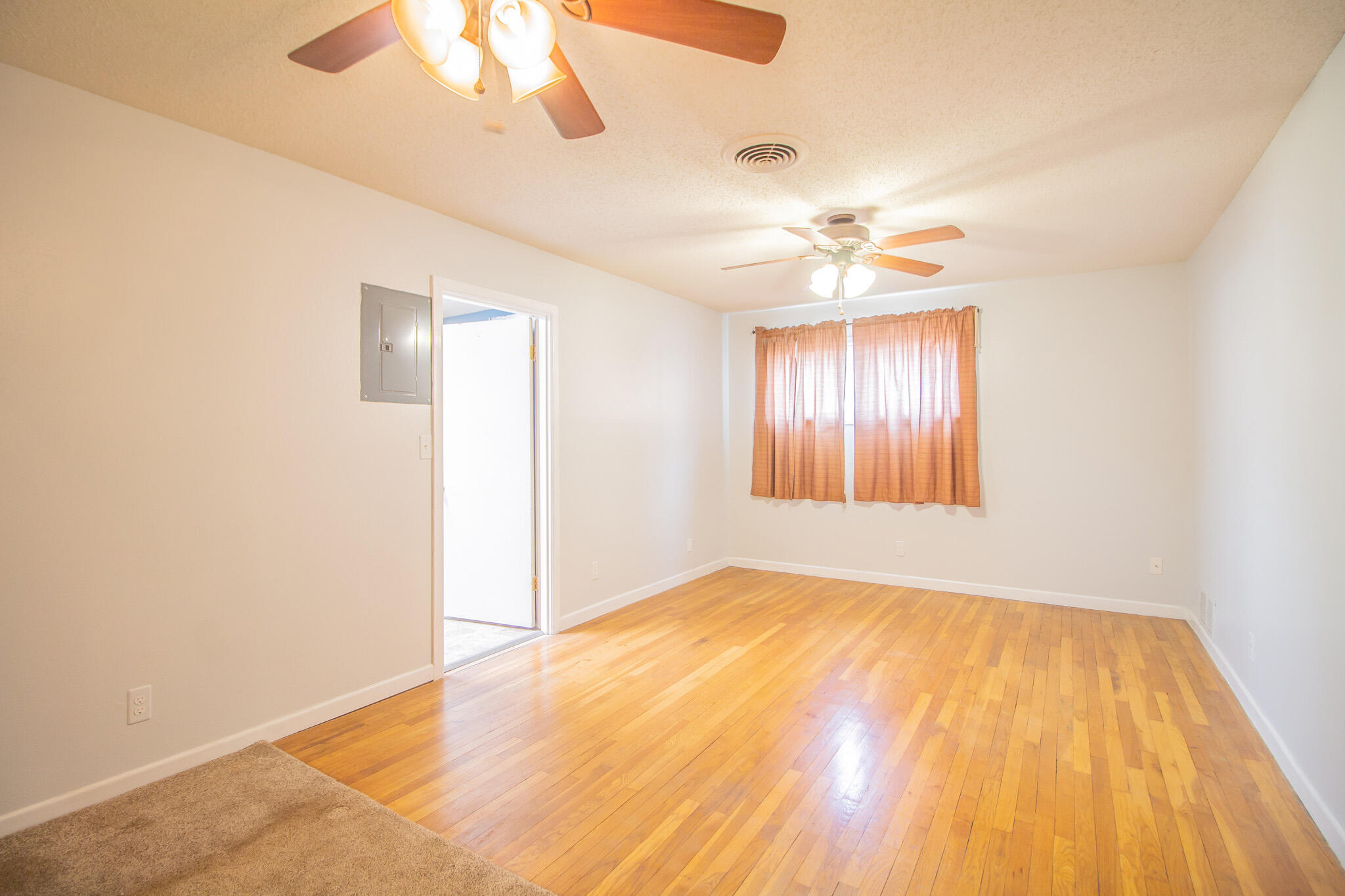 2806 58th Street Lubbock, TX 79413 - Photo 20 of 35 wooden floor in an empty room with a window
