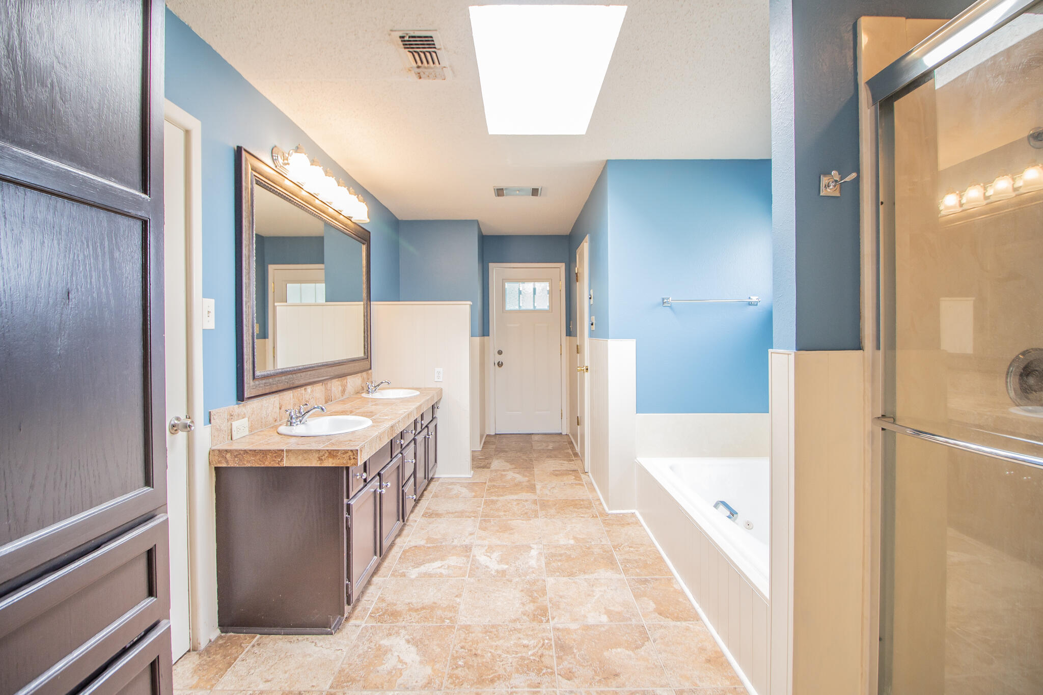 2806 58th Street Lubbock, TX 79413 - Photo 21 of 35 a bathroom with a tub sink and mirror