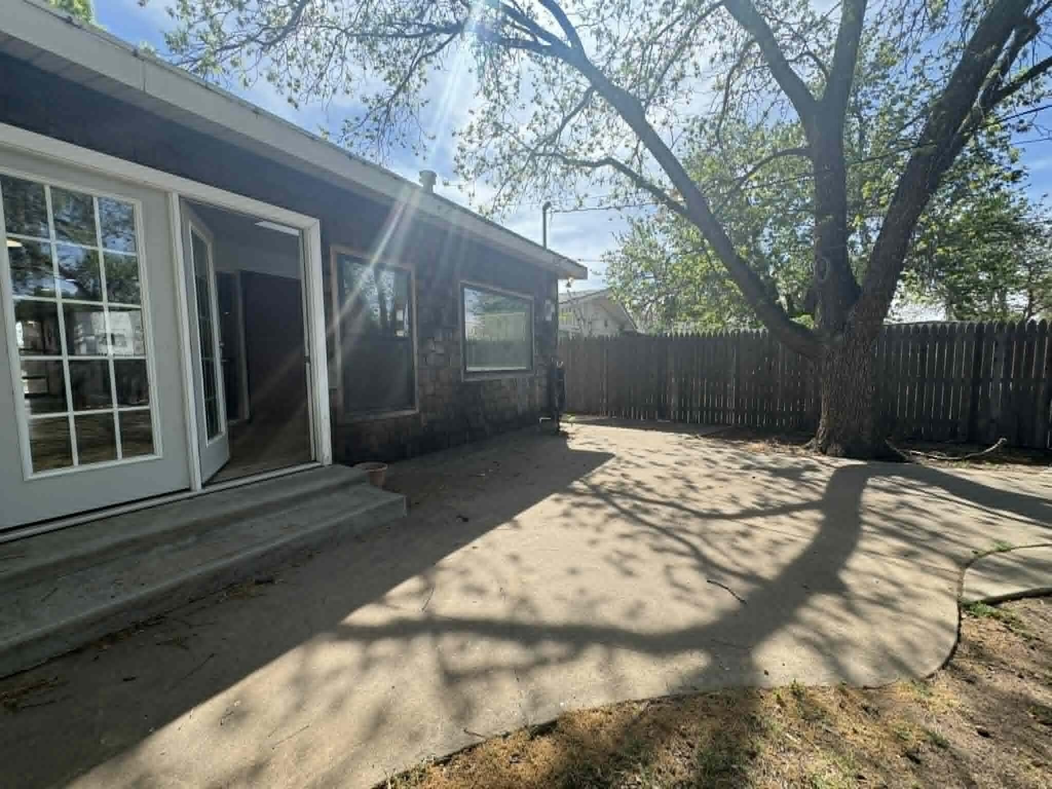 2806 58th Street Lubbock, TX 79413 - Photo 31 of 35 a view of backyard with large trees and wooden fence
