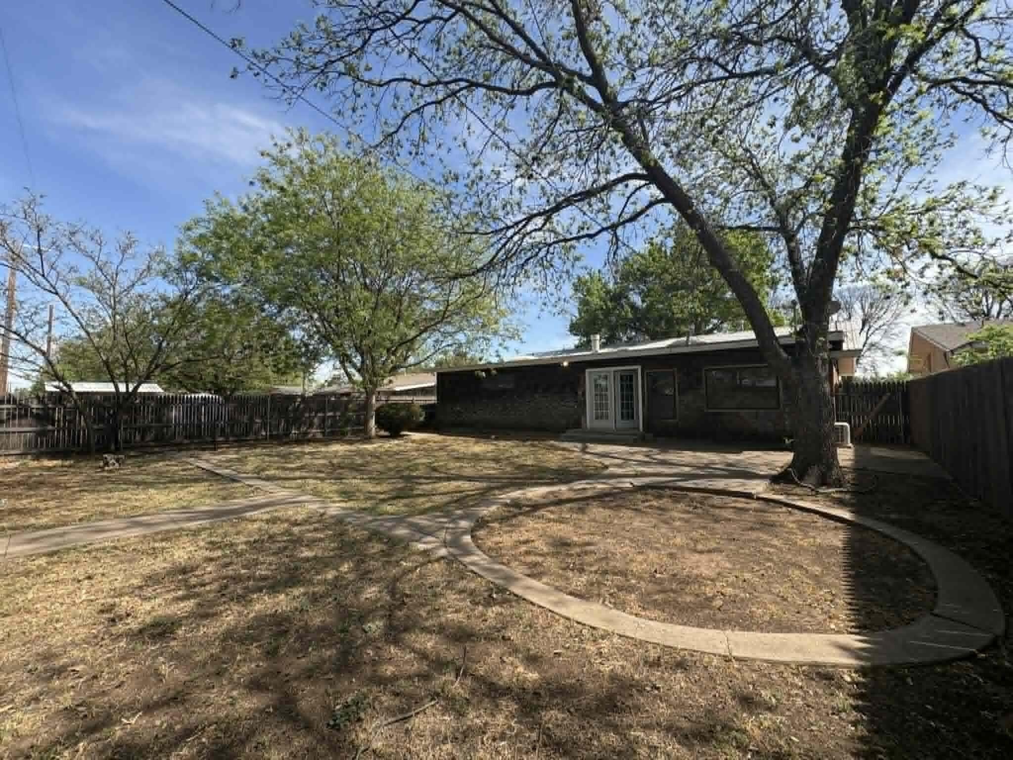 2806 58th Street Lubbock, TX 79413 - Photo 32 of 35 a backyard of a house with lots of green space