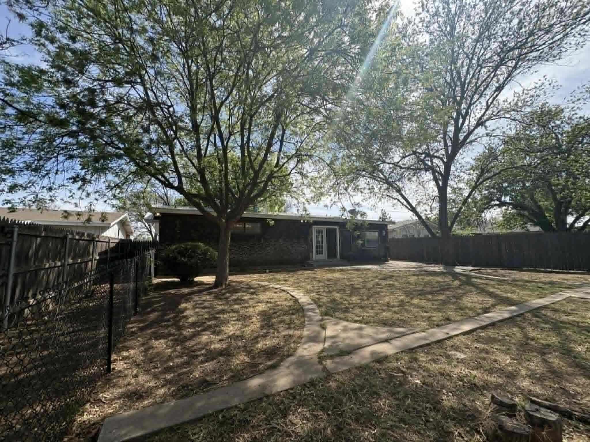 2806 58th Street Lubbock, TX 79413 - Photo 33 of 35 a backyard of a house with large trees