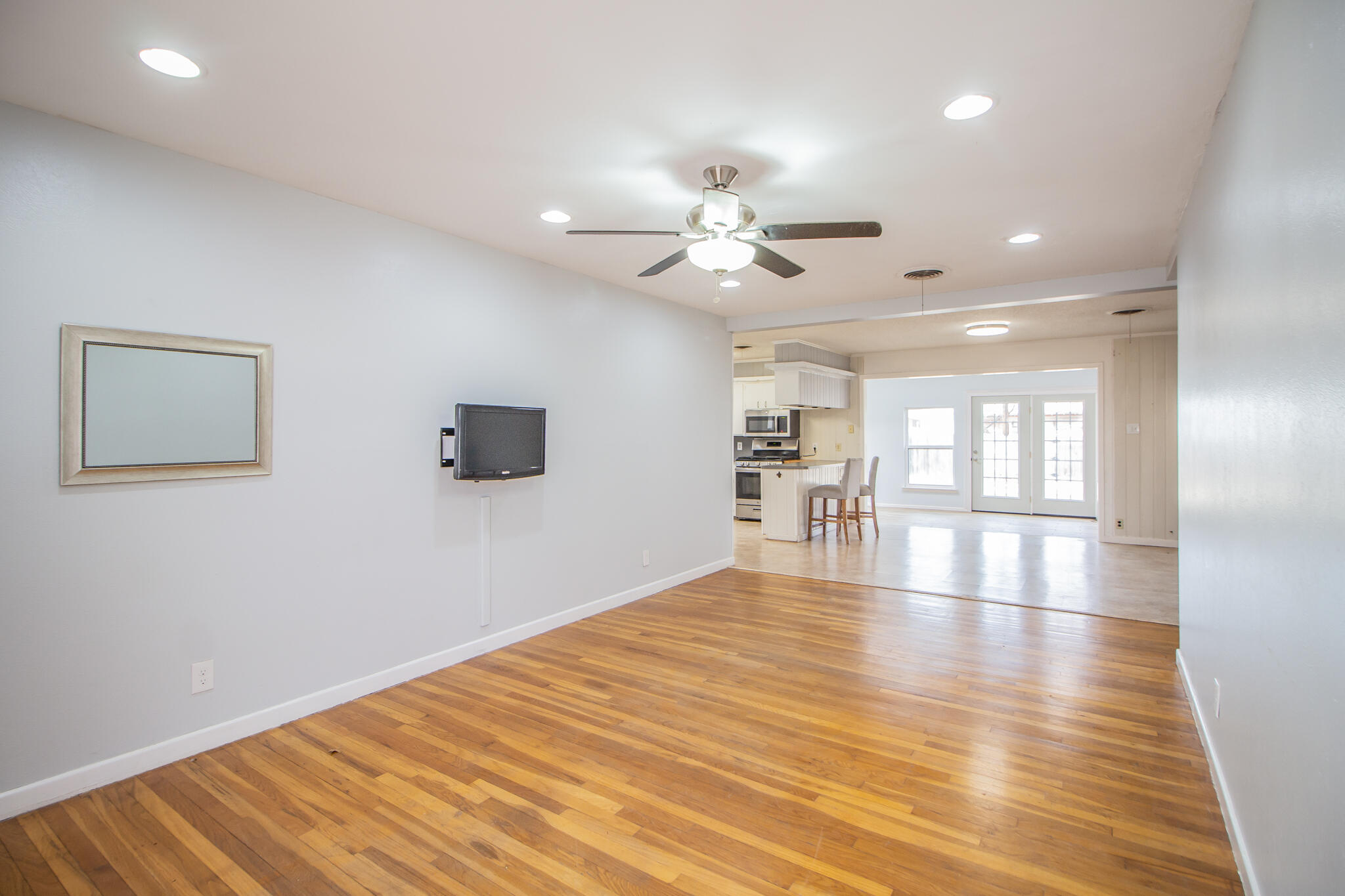 2806 58th Street Lubbock, TX 79413 - Photo 4 of 35 a view of an empty room with window and wooden floor