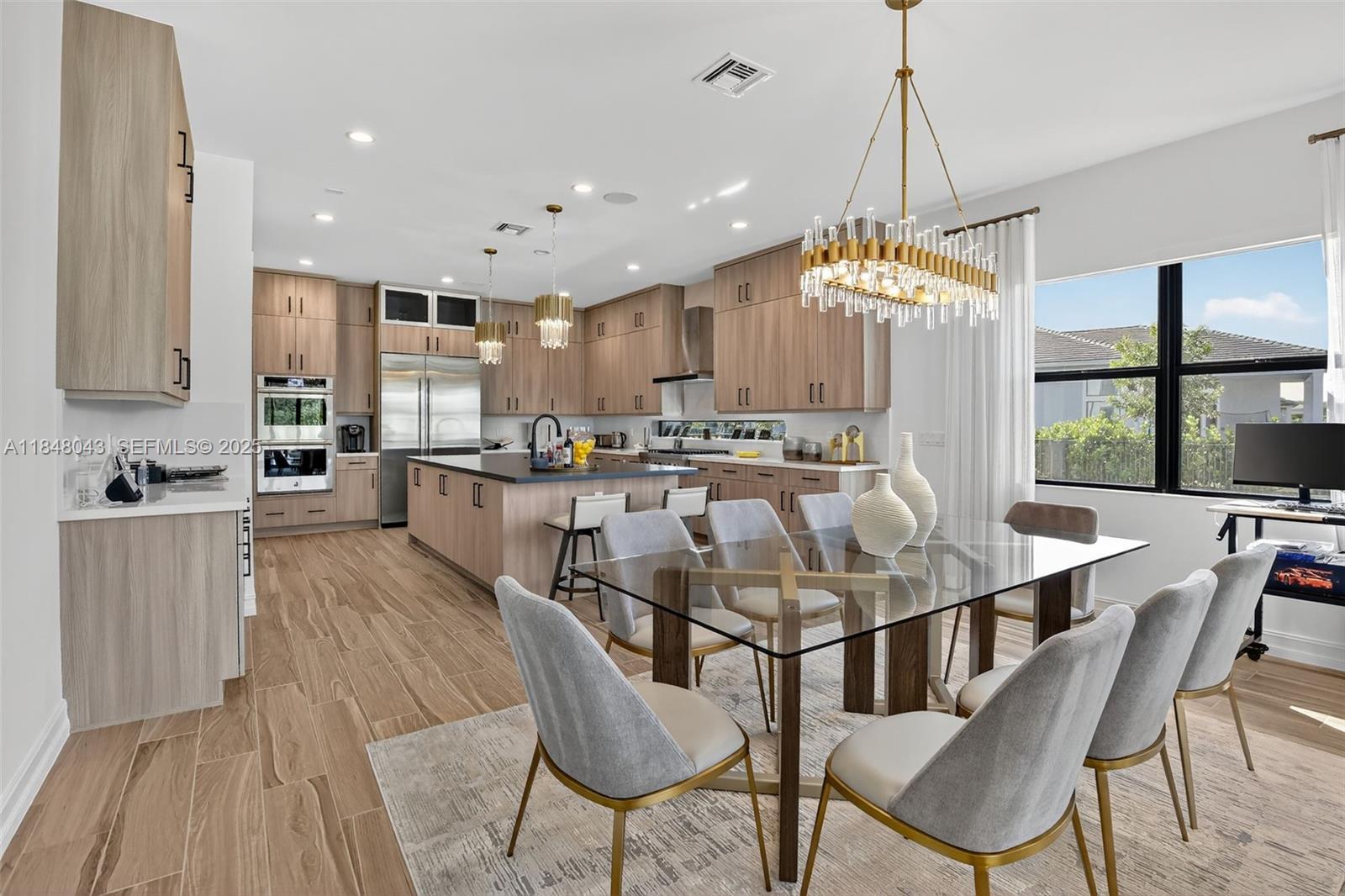 14855 Millstone Ranches Drive Davie, FL 33331 - Photo 15 of 94 a dining table chairs and a kitchen view