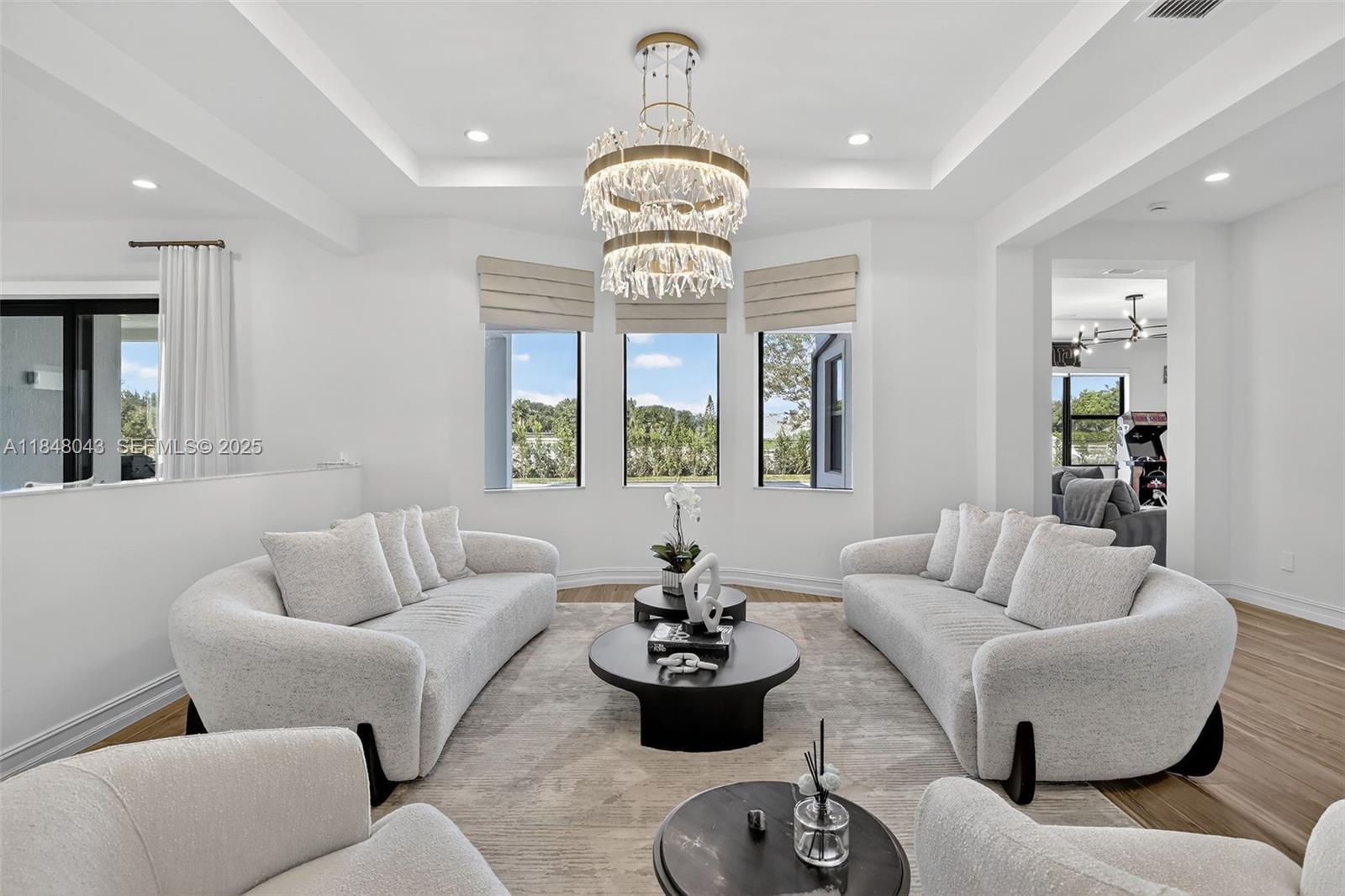 14855 Millstone Ranches Drive Davie, FL 33331 - Photo 19 of 94 a living room with furniture a chandelier and a large window