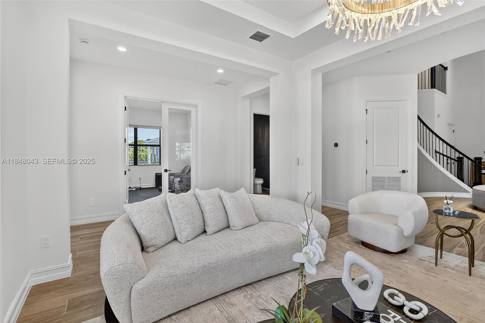 14855 Millstone Ranches Drive Davie, FL 33331 - Photo 21 of 94 a living room with furniture and a chandelier