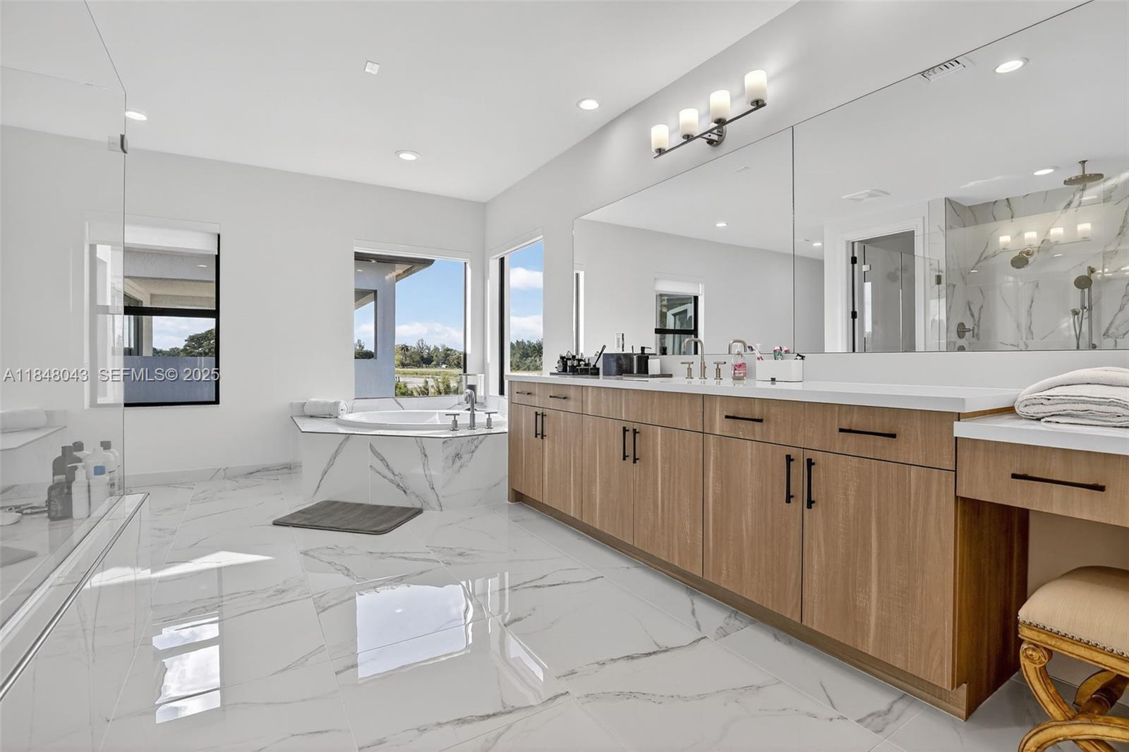 14855 Millstone Ranches Drive Davie, FL 33331 - Photo 31 of 94 a large white kitchen with a sink a stove a dining table and chairs