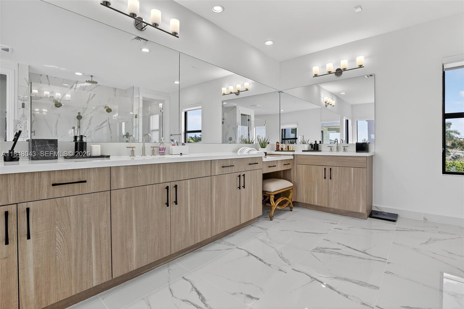 14855 Millstone Ranches Drive Davie, FL 33331 - Photo 32 of 94 a large white kitchen with kitchen island a sink a stove a dining table and chairs