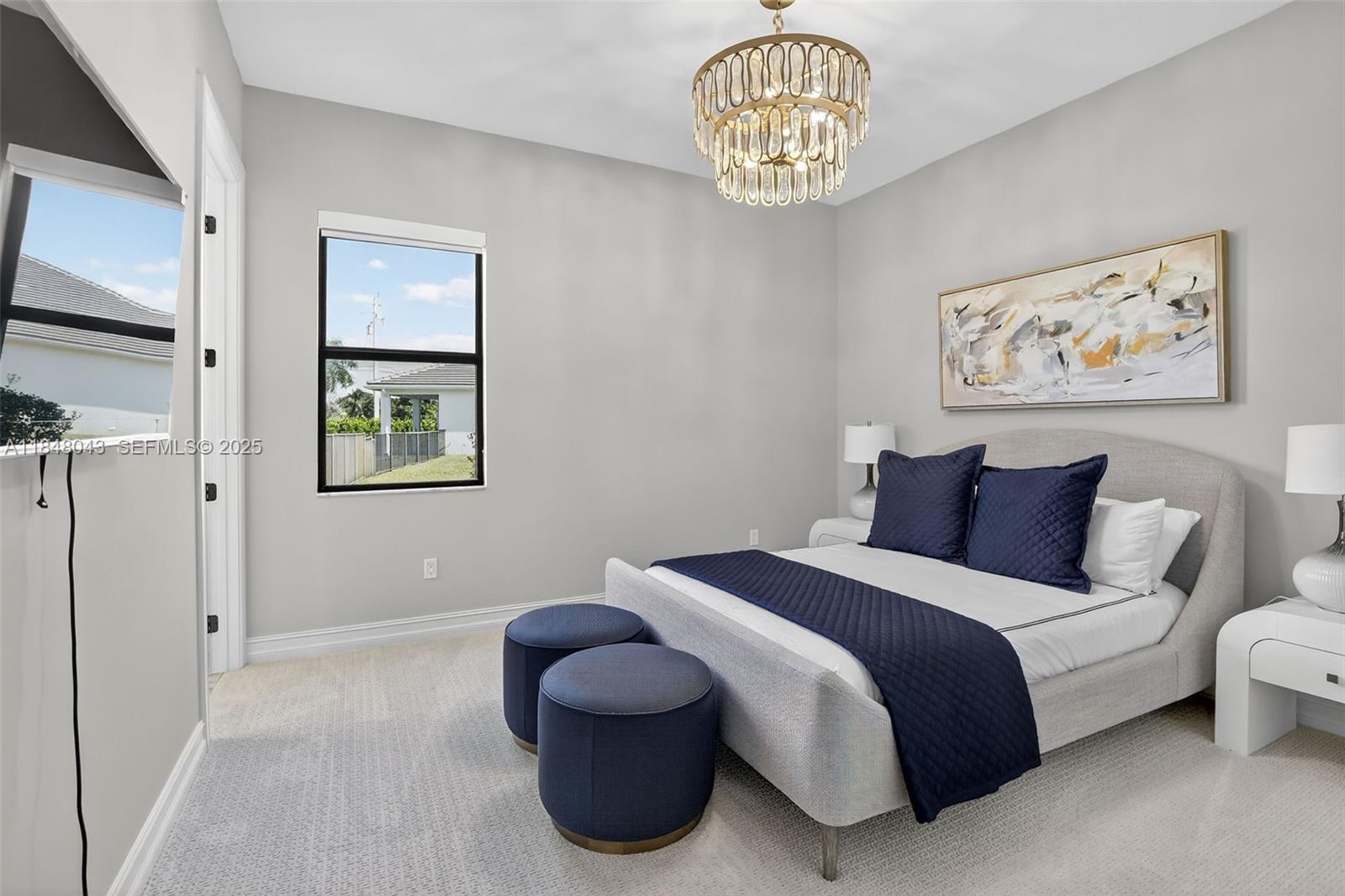14855 Millstone Ranches Drive Davie, FL 33331 - Photo 41 of 94 a bedroom with a bed and a chandelier