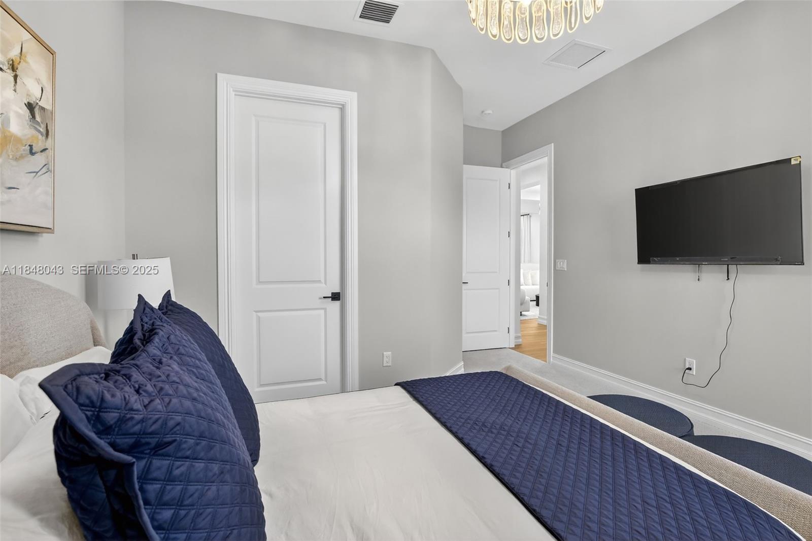 14855 Millstone Ranches Drive Davie, FL 33331 - Photo 43 of 94 a bedroom with a bed and a flat screen tv