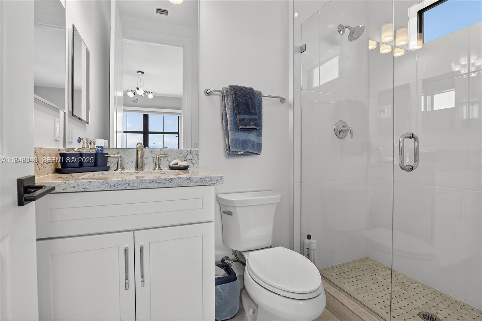 14855 Millstone Ranches Drive Davie, FL 33331 - Photo 44 of 94 a bathroom with a granite countertop sink toilet a mirror a shower and vanity