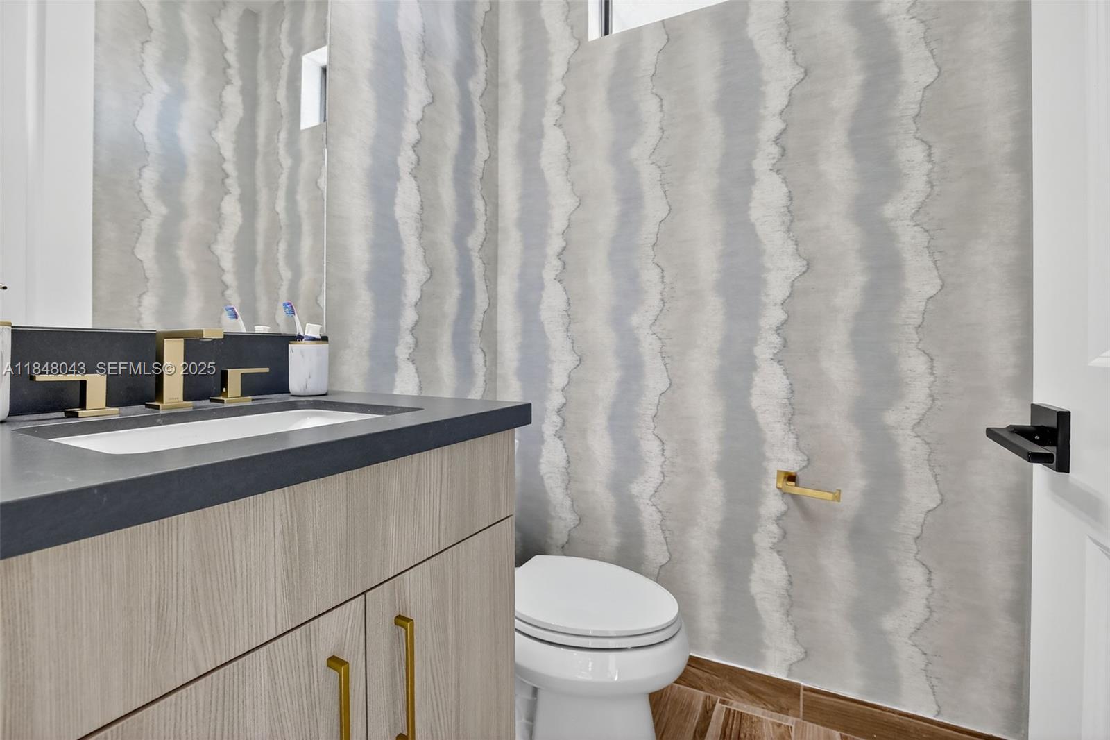 14855 Millstone Ranches Drive Davie, FL 33331 - Photo 54 of 94 a bathroom with a granite countertop sink toilet and a mirror