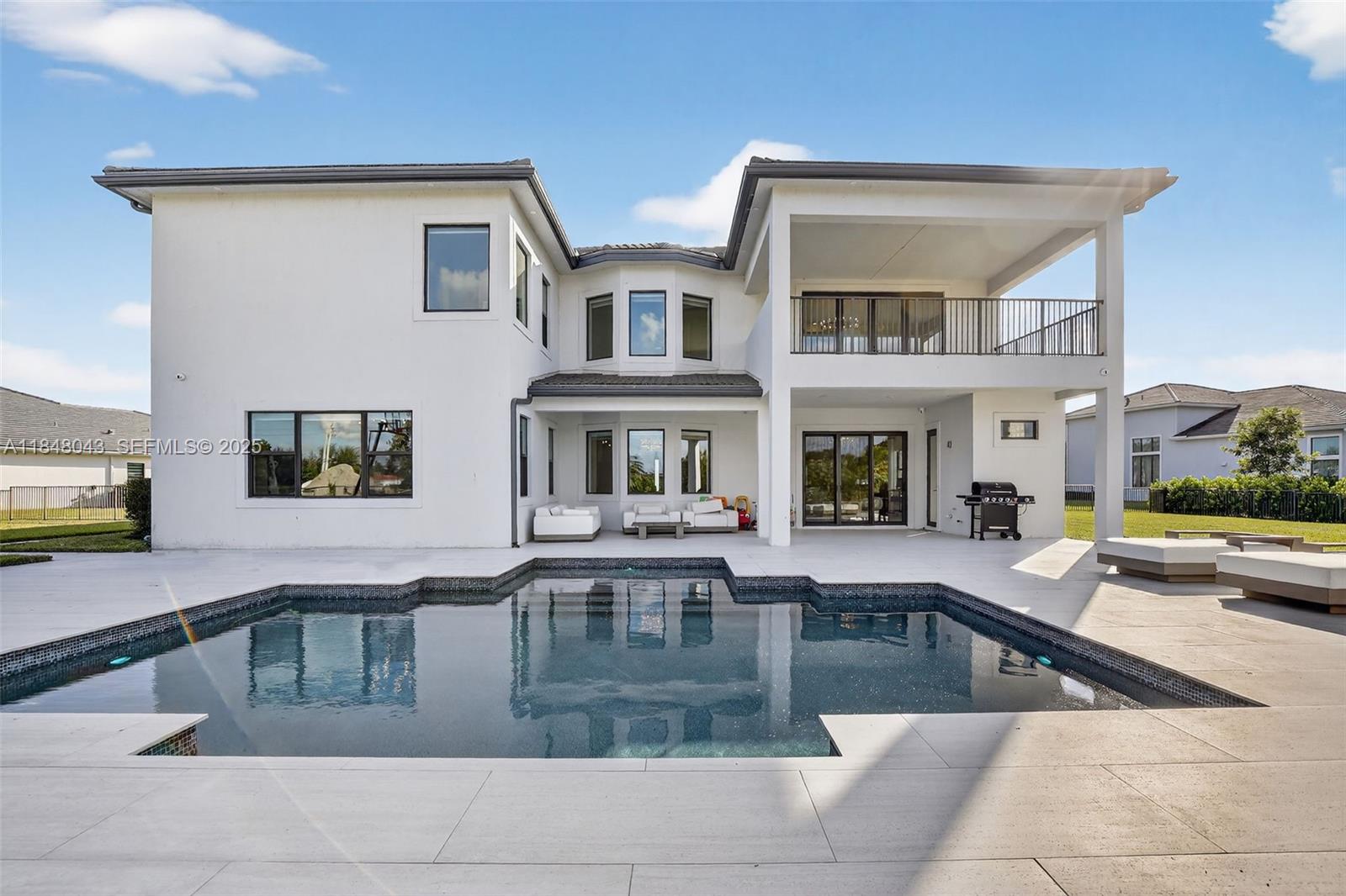 14855 Millstone Ranches Drive Davie, FL 33331 - Photo 6 of 94 a view of a swimming pool with outdoor seating