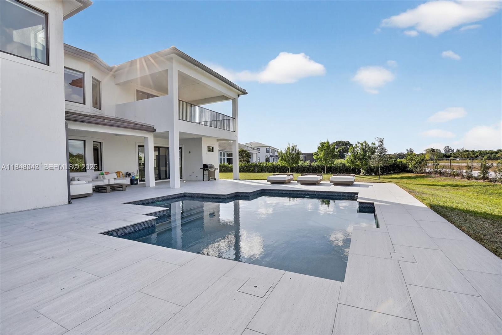 14855 Millstone Ranches Drive Davie, FL 33331 - Photo 7 of 94 a view of a swimming pool with lounge chair