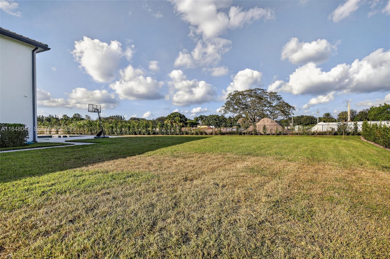14855 Millstone Ranches Drive Davie, FL 33331 - Photo 90 of 94 a view of a golf course with a lake