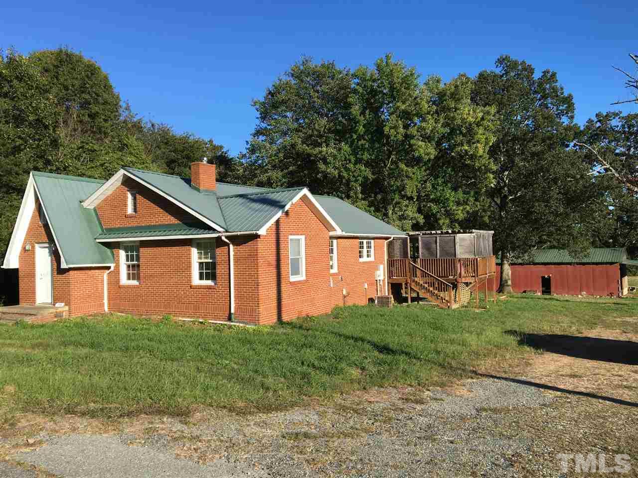 9516 Virgilina Road Roxboro, NC 27574 - Photo 1 of 21 a front view of a house with a yard and garage