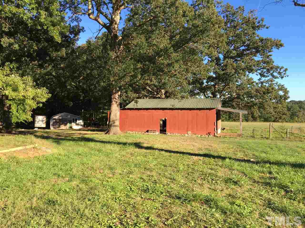 9516 Virgilina Road Roxboro, NC 27574 - Photo 2 of 21 a view of a yard with an tree